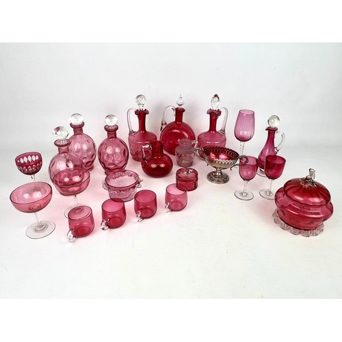 100 - A collection of antique and later cranberry glass - including a pair of claret jugs with moulded qui... 