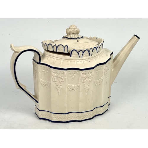 24 - An early 19th century Feldspathic stoneware teapot in the 'Castleford' style, with sliding lid, the ... 