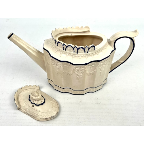 24 - An early 19th century Feldspathic stoneware teapot in the 'Castleford' style, with sliding lid, the ... 