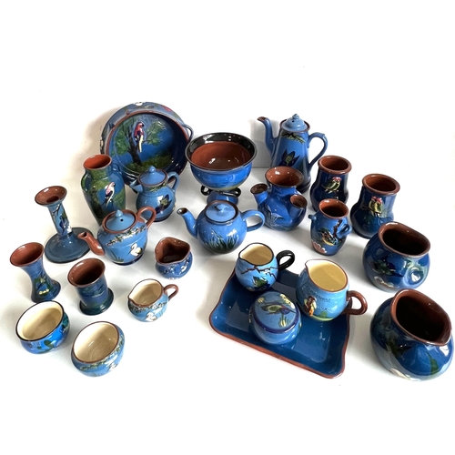 29 - A collection of blue glazed Torquay pottery - including pieces with seagull, parrot, kingfisher, her... 