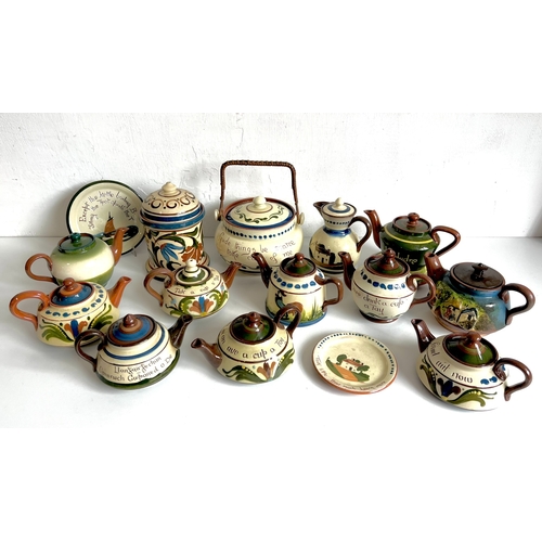 30 - A collection of Torquay pottery teapots, teapots stands, biscuit jars and a lidded jug - including S... 