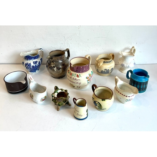 45 - A small collection of 19th and 20th century china and pottery jugs - including a majolica glazed she... 