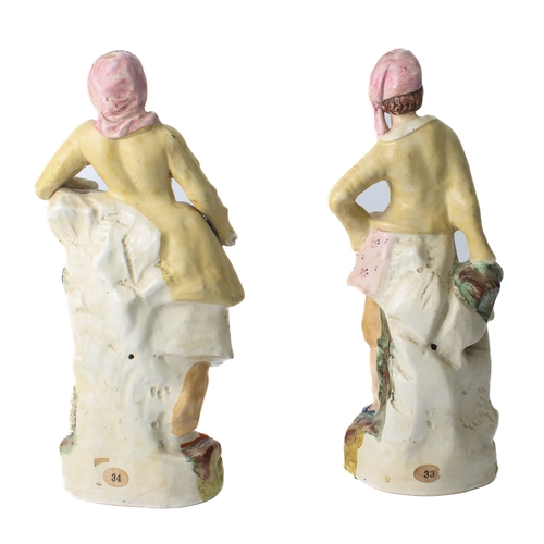 19 - A pair of mid-19th century Staffordshire figures of a shepherd and shepherdess – the shepherd with h... 