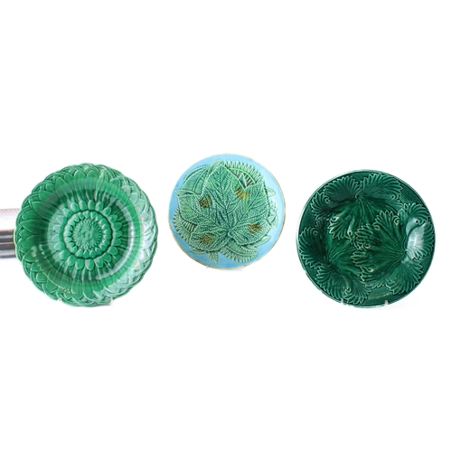 25 - A group of pottery plates and bowls - including two Victorian green majolica glazed 'cabbage' plates... 