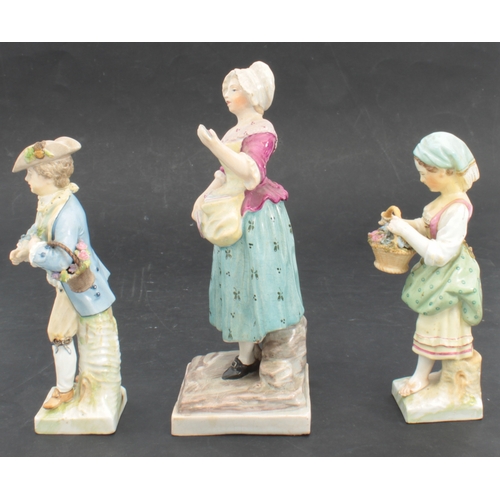 87 - A pair of Continental porcelain figures of a flower girl and boy - underglaze blue Berlin style mark... 