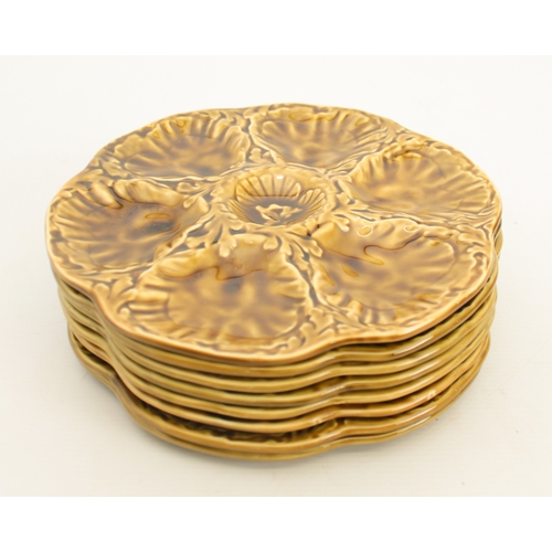 90 - A set of French Gien oyster plates - black printed factory marks, glazed in ochre, 23.75cm diameter.