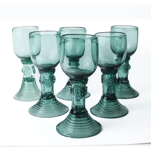 100 - A set of six Continental roemer style green wine glasses - probably 19th century, the ovoid bowls on... 