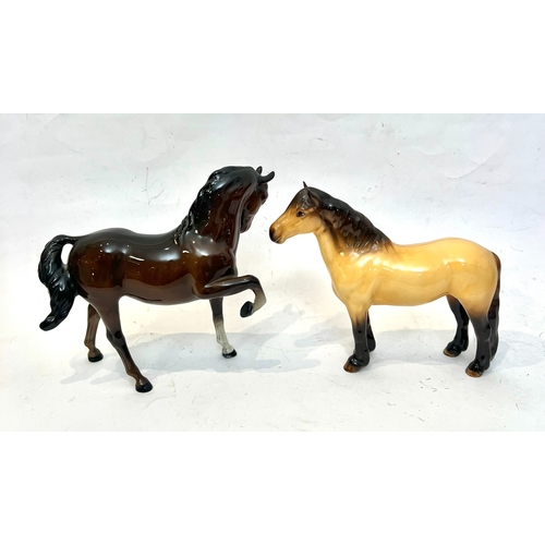 49 - Four Beswick horse figurines - comprising a 1644 dun Highland Pony; a 1549 Tucked Head Horse, chestn... 