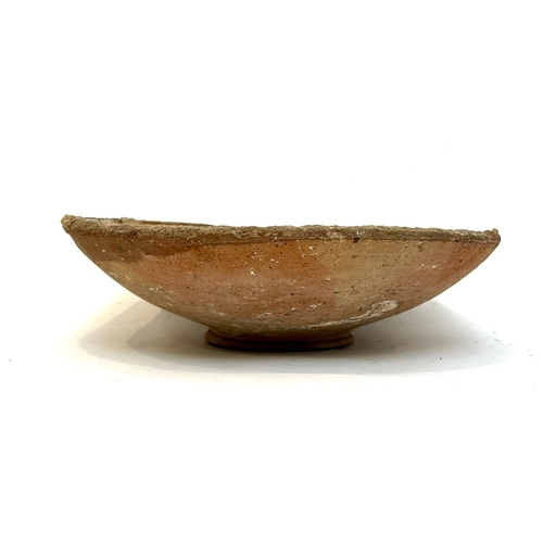 81 - A Romano British terracotta bowl, probably AD43-AD410 - heavily potted, of uneven shallow dished for... 