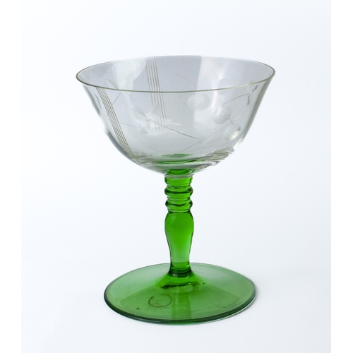 94 - A set of six green glass wine glasses, early 20th century - the ogee bowls on ball knopped stems and... 