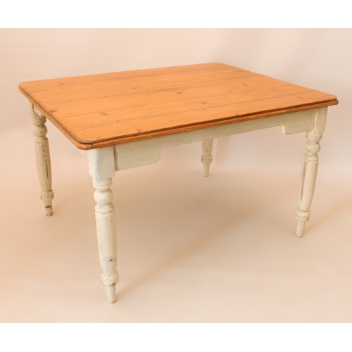 A six-seater pine and white painted farmhouse kitchen table - the waxed pine top raised on painted t