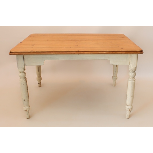 A six-seater pine and white painted farmhouse kitchen table - the waxed pine top raised on painted t