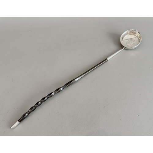 An 18th century white metal and baleen toddy ladle - the circular bowl ...