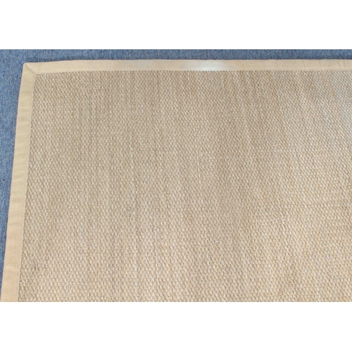 A large sisal rug - with bound edges, 313 x 219cm. (centre of one long ...
