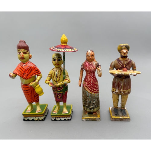 A group of ten carved wooden and hand painted Indian figures - mostly ...