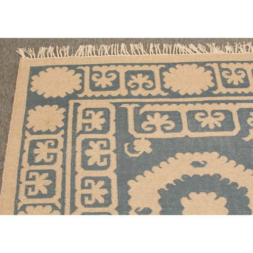 An OKA Chelak flatweave wool rug - in indigo blue and natural colourway ...