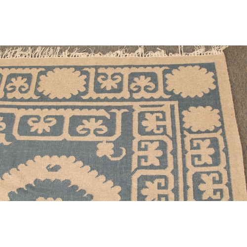 An OKA Chelak flatweave wool rug - in indigo blue and natural colourway ...