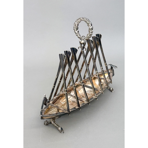 A Victorian silver plated novelty toast rack in the form of a rowing ...
