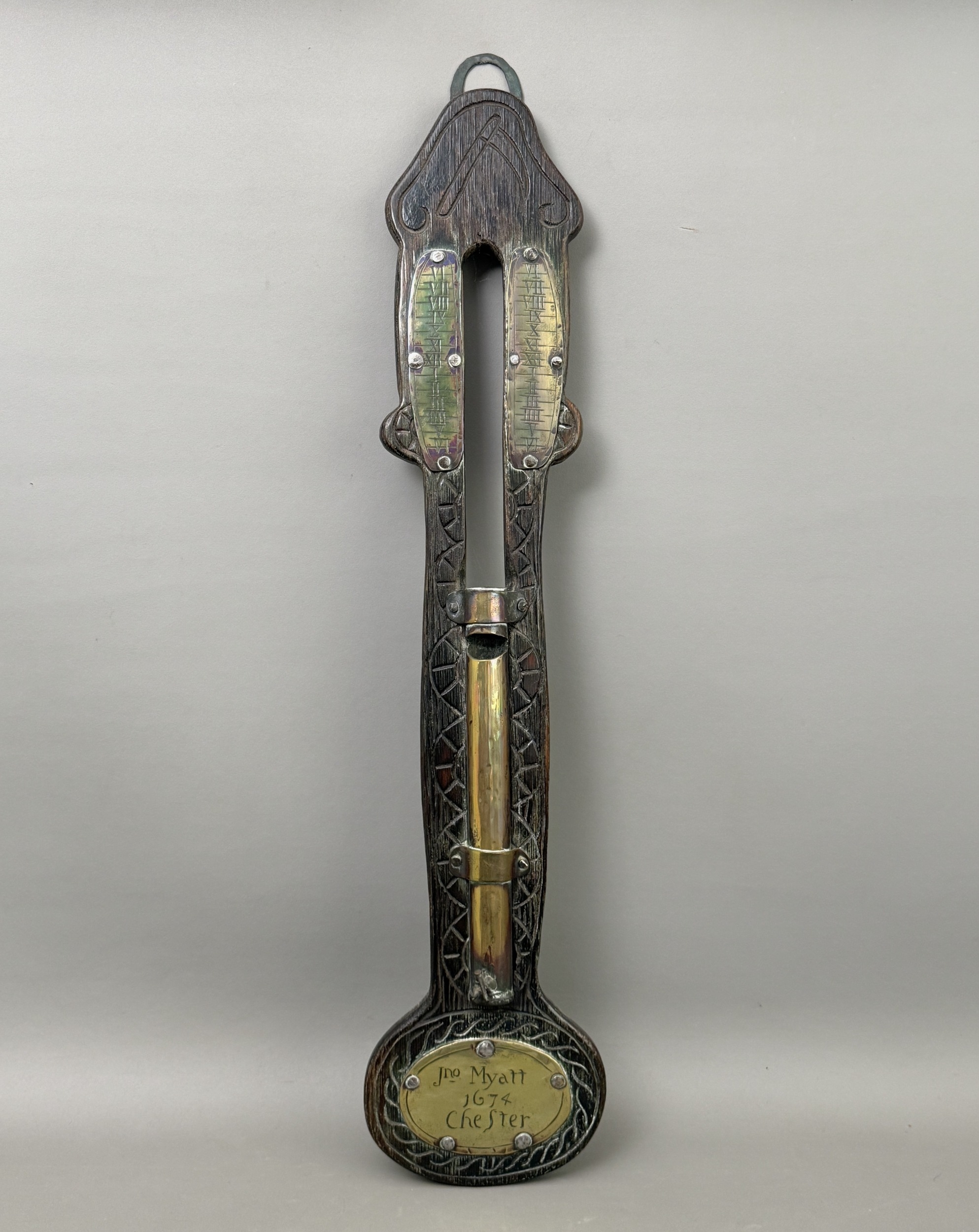 An antique carved oak wall hanging water clock - applied with brass ...