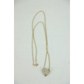 An attractive 10ct gold Chain, with decorative heart shaped pendant set with three central diamonds ... 