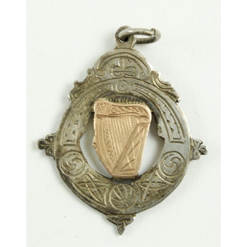 573 - Medal: G.A.A., Co. Cork (1947) A silver shield shaped Medal, with pierced centre and rose gold harp ... 