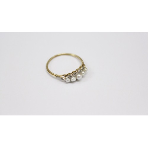 512 - An 18ct gold Ring, with five graduating pearls, set with .1ct of diamond chips, size L 1/2. (1)... 