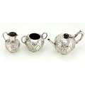 An attractive Victorian silver Bachelors Tea Service, with repouss decoration comprising a teapot, ... 
