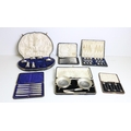 A varied collection of cased silver Presentation Sets, of spoons, butter dishes, knives, teaspoons, ... 