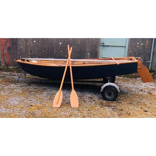 10 - A 11' Mirror Sailing Boat, with sails, oars, canvas cover, and a two wheel trailer. (1)