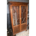 A mahogany Chippendale style Wardrobe, with two glazed and panel doors, on bracket feet. (1)