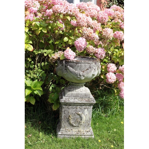 27 - A pair of attractive Victorian style composition Garden Urns on stands, decorated in the Adams taste... 