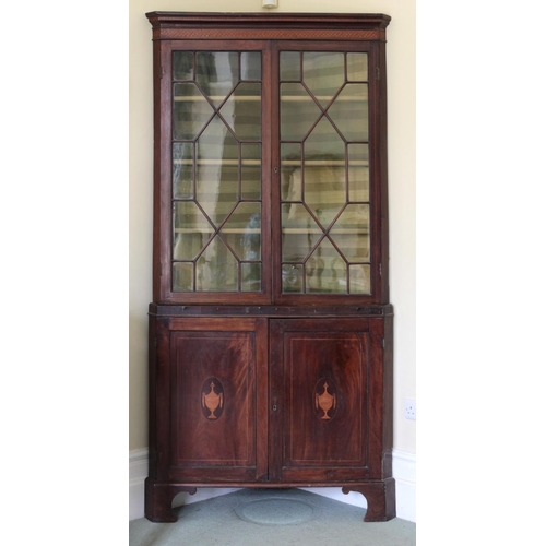 285 - A George III period mahogany and satinwood inlaid Corner Cabinet, the super structure with dentil in... 