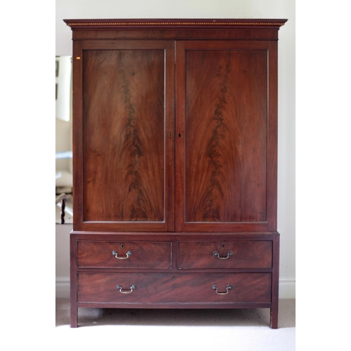 290 - A 19th Century figured mahogany two door Wardrobe, on a base with two short and one long drawer, on ... 