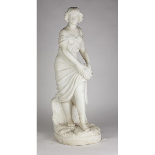 338 - An attractive carved marble Statue of a young Lady, in long and low cut dress, standing on a natural... 