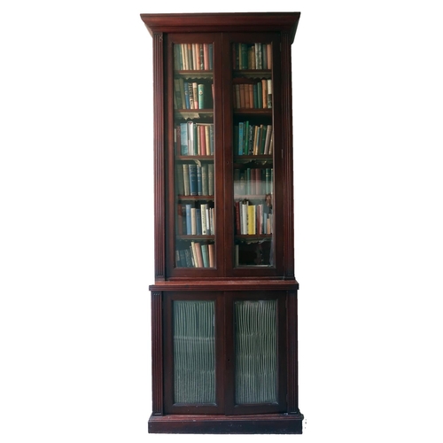 340 - A very tall 19th Century mahogany two door Bookcase, with moulded cornice, reeded sides on a base wi... 