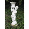 A pair of large cast iron Urns, with cherubs holding reeded vases, on circular plinth base, each app... 