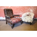 A large carved Victorian mahogany Armchair, with deep buttoned back, upholstered arms supported by t... 