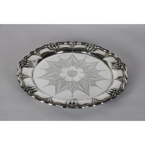 135 - An attractive large heavy English circular silver Salver, with shaped rim and decorated border, the ... 
