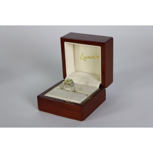 157 - An exquisite 3 stone diamond Ring, by Lunns of Belfast, with 2.93ct fancy intense yellow centre ston... 