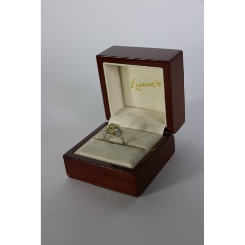 157 - An exquisite 3 stone diamond Ring, by Lunns of Belfast, with 2.93ct fancy intense yellow centre ston... 