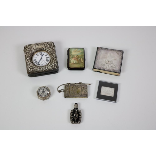 175 - A silver mounted cased Travel Clock, a modern Irish silver mounted Note Book, 