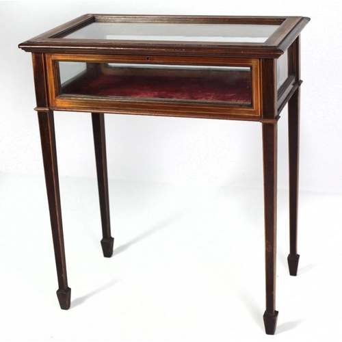 177 - An Edwardian inlaid mahogany Curio Table, with glazed lift top, on square tapering legs. (1)