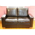 A modern two seater leather Couch. (1)