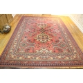 An attractive Turkish heavy woolen Carpet, with large pink ground central panel, and borders of simi... 