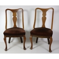 A pair of Edwardian walnut Dining Chairs, with upholstered seats on cabriole legs. (2)