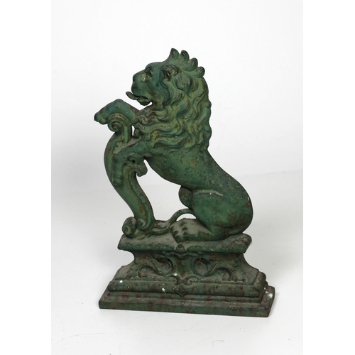 134 - A Victorian cast iron Door Stop, modelled as a rampant lion on a plinth base, painted green, approx.... 