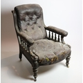 A carved Edwardian walnut Library Armchair, covered in hide. (1)