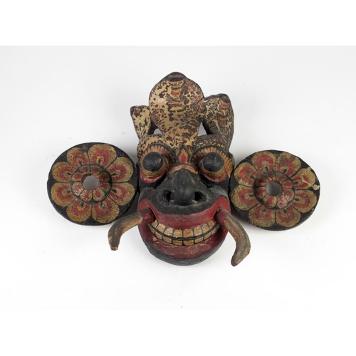 381 - An early 19th Century Oceanic painted Tribal Figure with feather like crown, enlarged circular ears,... 