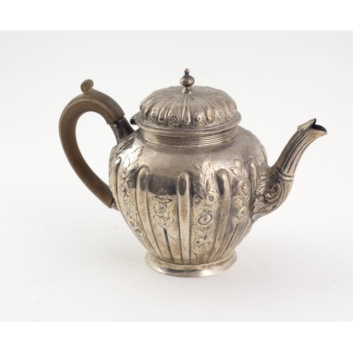 403 - An attractive small Victorian silver Teapot, with reeded and floral embossed decorated body and wood... 