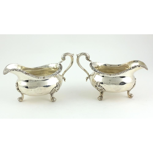 404 - A very heavy pair of early George IV English silver Sauceboats, with gadroon edges and scroll handle... 